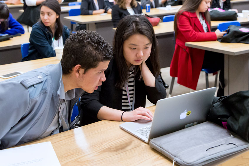 Two students looking at a laptop.