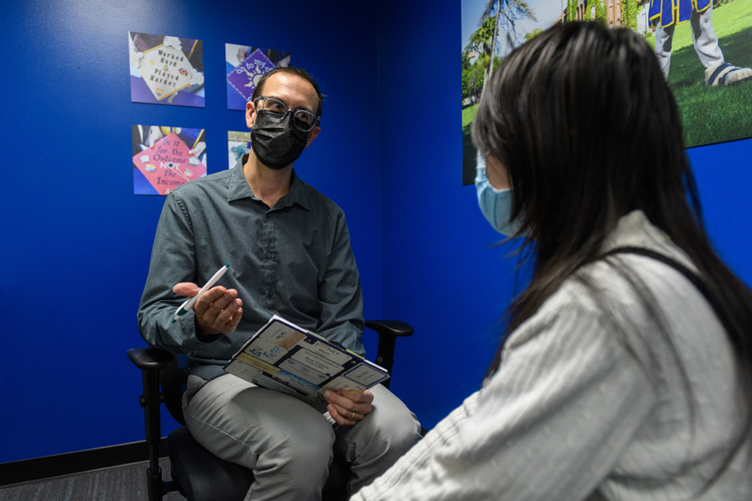 An SJSU Cares staff member talking to a student.