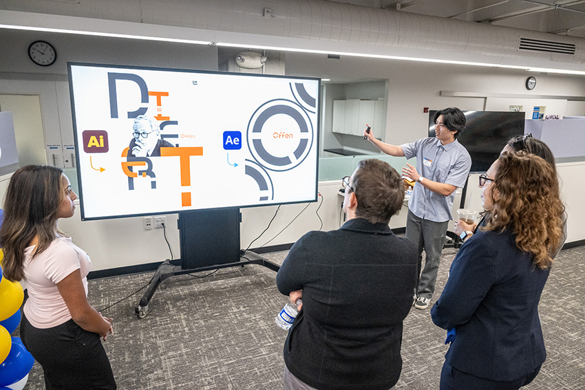 students interacting with a display at the Elevate Career Hub
