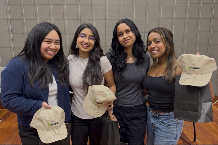 SJSU Students hold hats signed by co-founder, president and CEO of NVIDIA, Jensen Huang. 