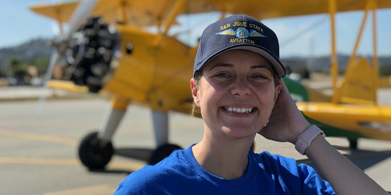 Aviation students selfie with a yellow plane background