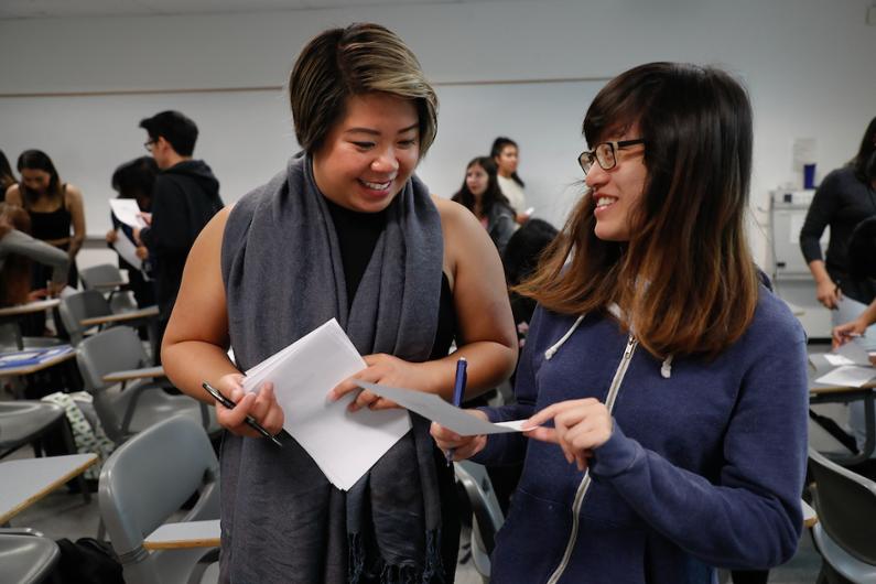 a female faculty member collaborates with a student in the classroom