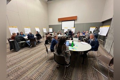 photo shows meeting with faculty groups at various tables in meeting roomirectors Support