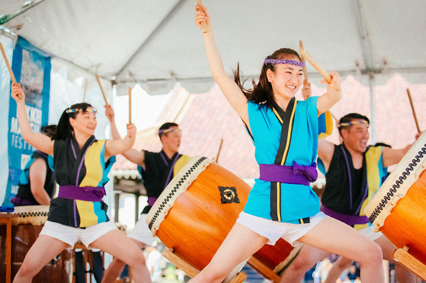 A group of drummers performing on stage.