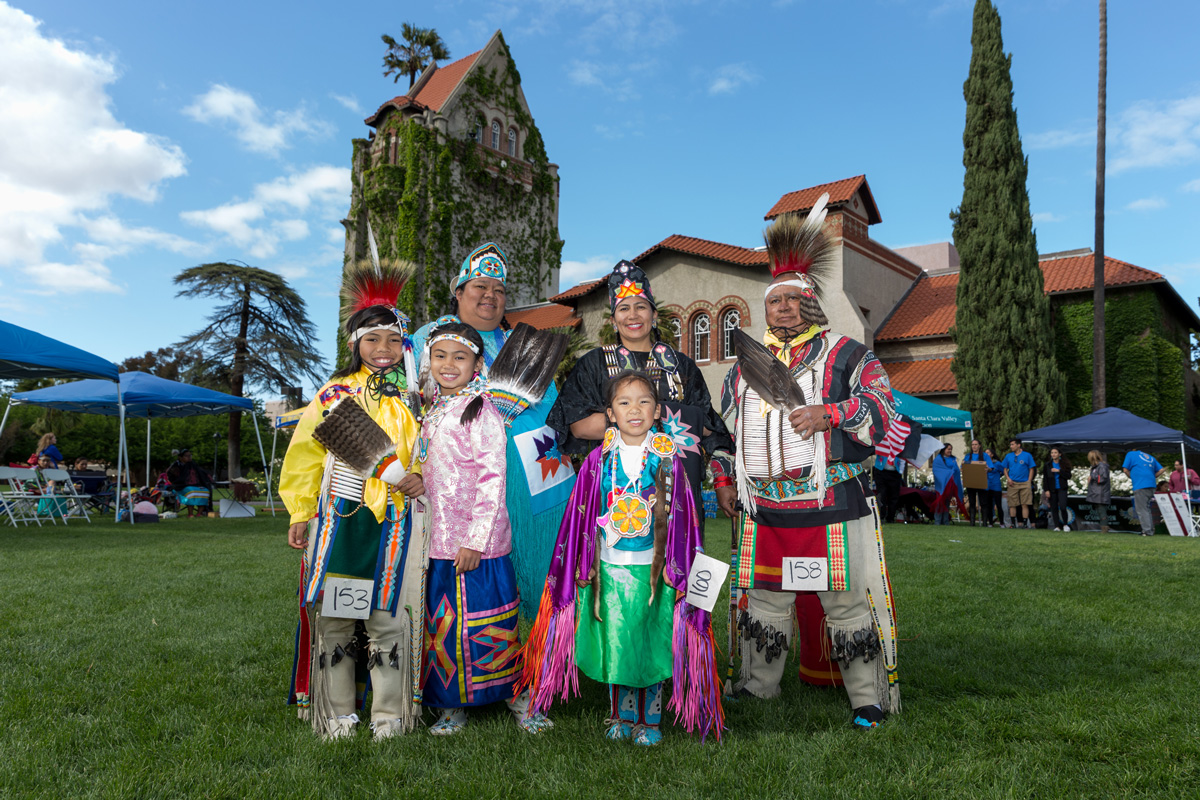 Tribal members in traditional attire.