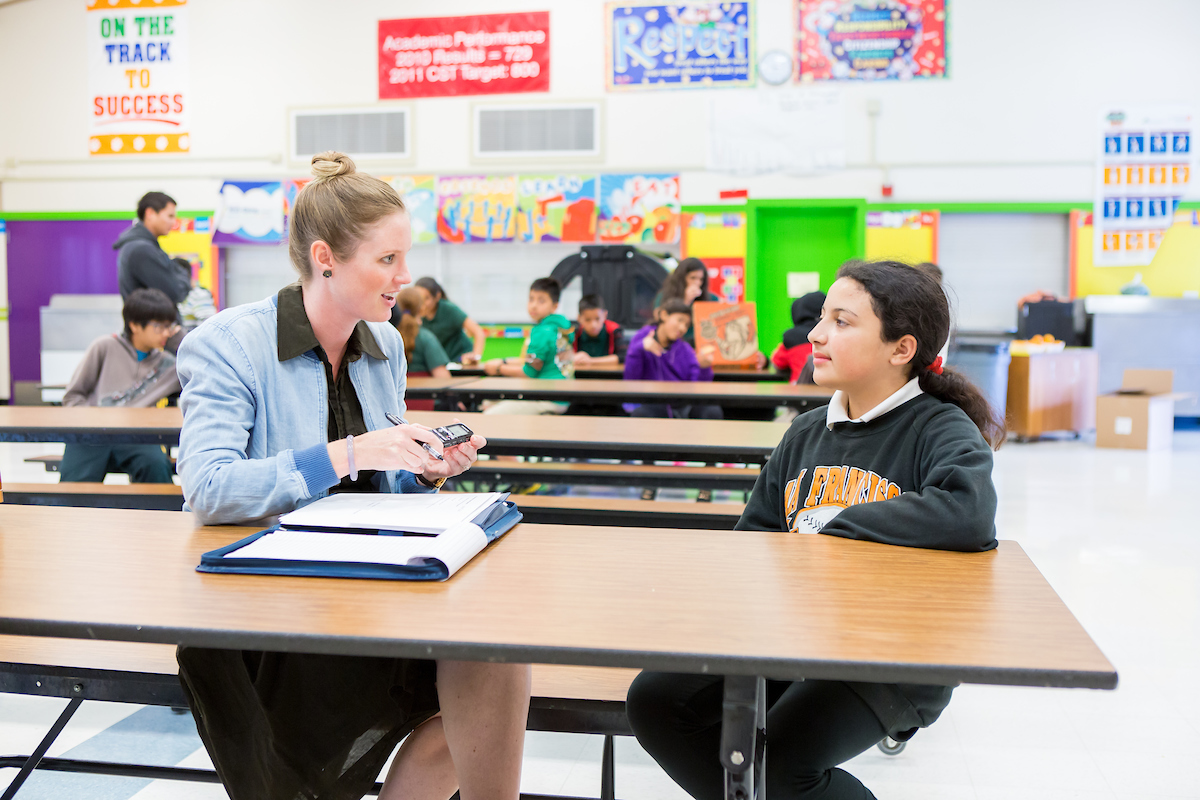 student and teacher speaking