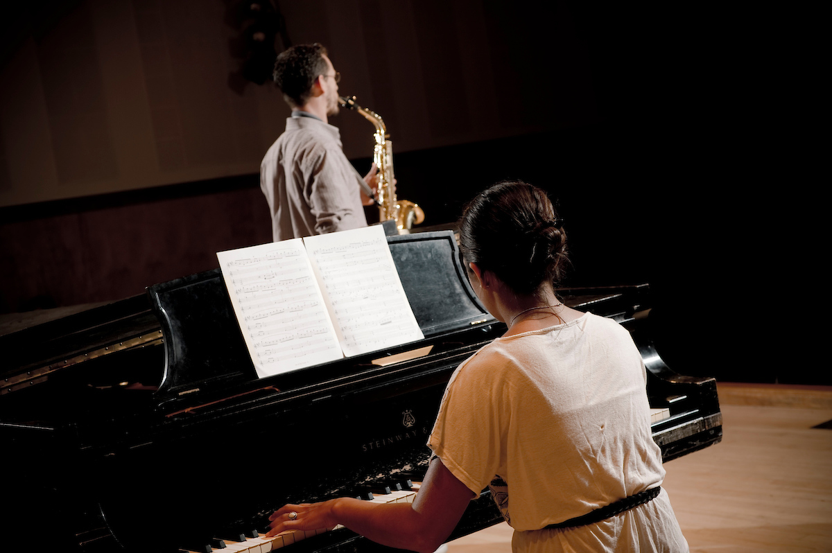 students in a piano class