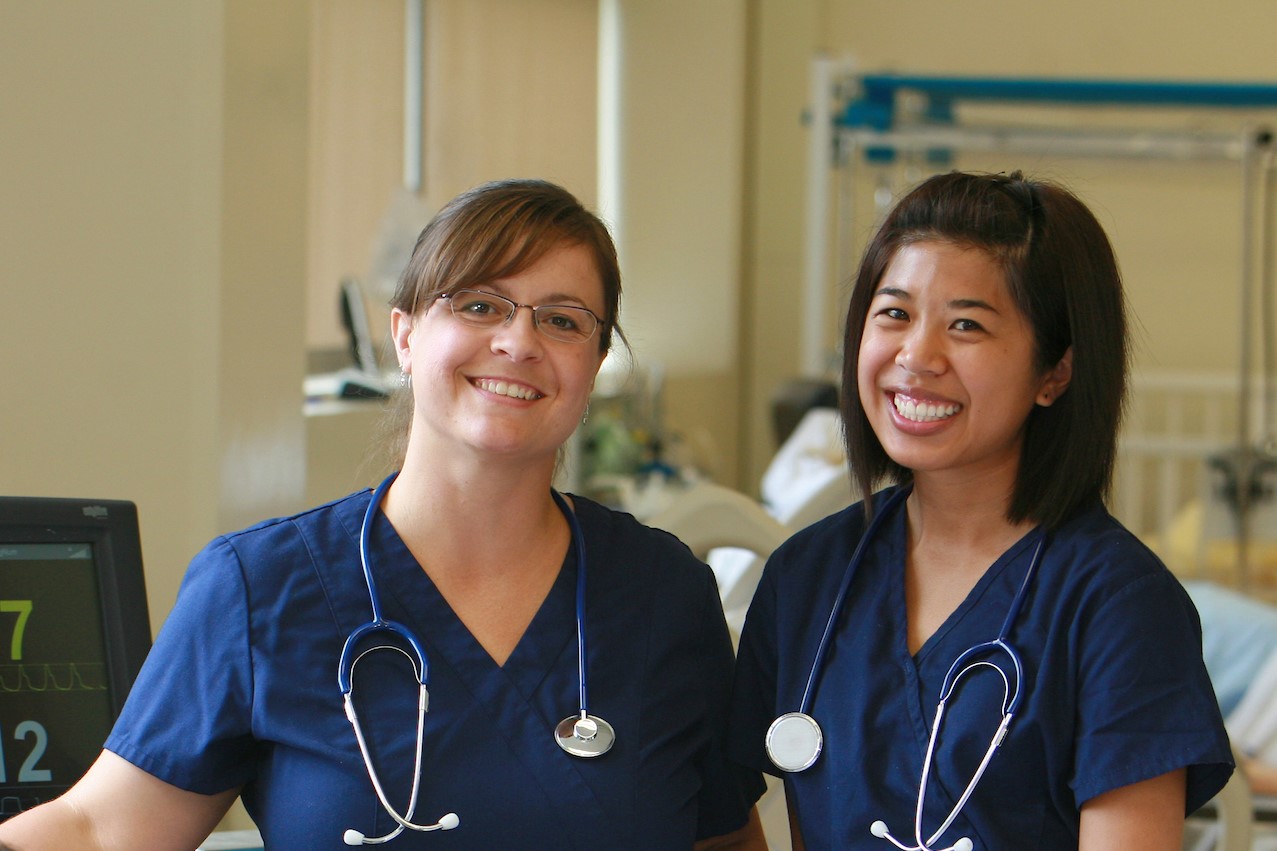 Two nursing students pose side by side