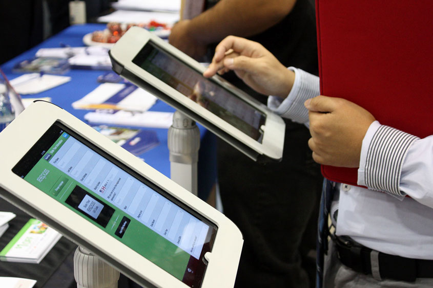 Students interacting with two mounted iPads and the applications.