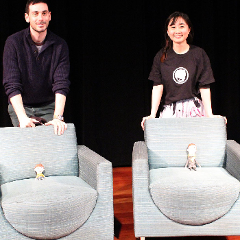 Two People standing in front of chairs