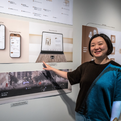 Designer Yulie Dai posing with her work