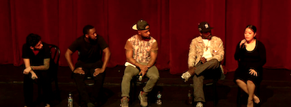 5 people on stage with red curtain.