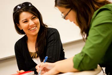 Two students laugh together while studying at San José State University.