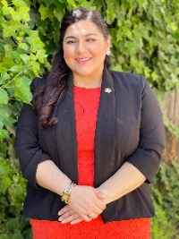 color portrait on a background of leaves of Dr. Monica A. Kapil