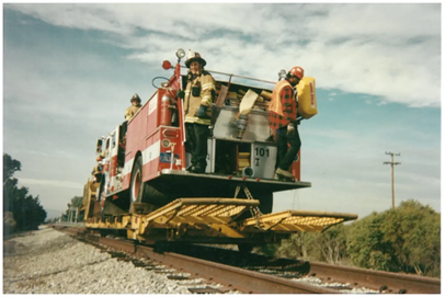 Fire truck loaded up on special rail equipment on the way to the Dumbarton