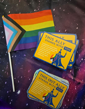 Collage featuring the progress pride flag, and stickers labled "This ally stands with you" and "This out ally stands with you."