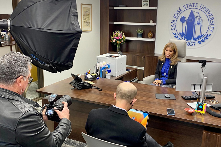 President Teniente-Matson speaking with media folks in her office.