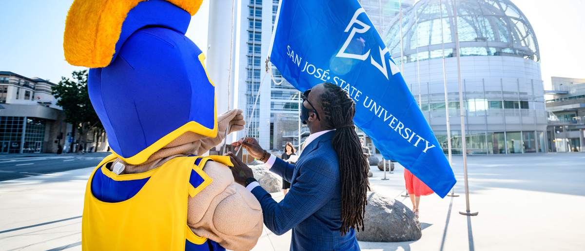 SJSU Staff and Sammy pull the rope to raise the SJSU flag at City Hall.