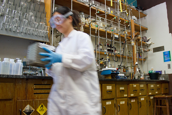 woman in lab coat works in a lab