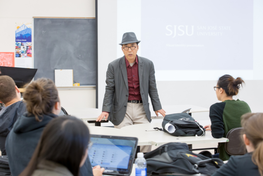 A person presenting to a group of seated individuals.