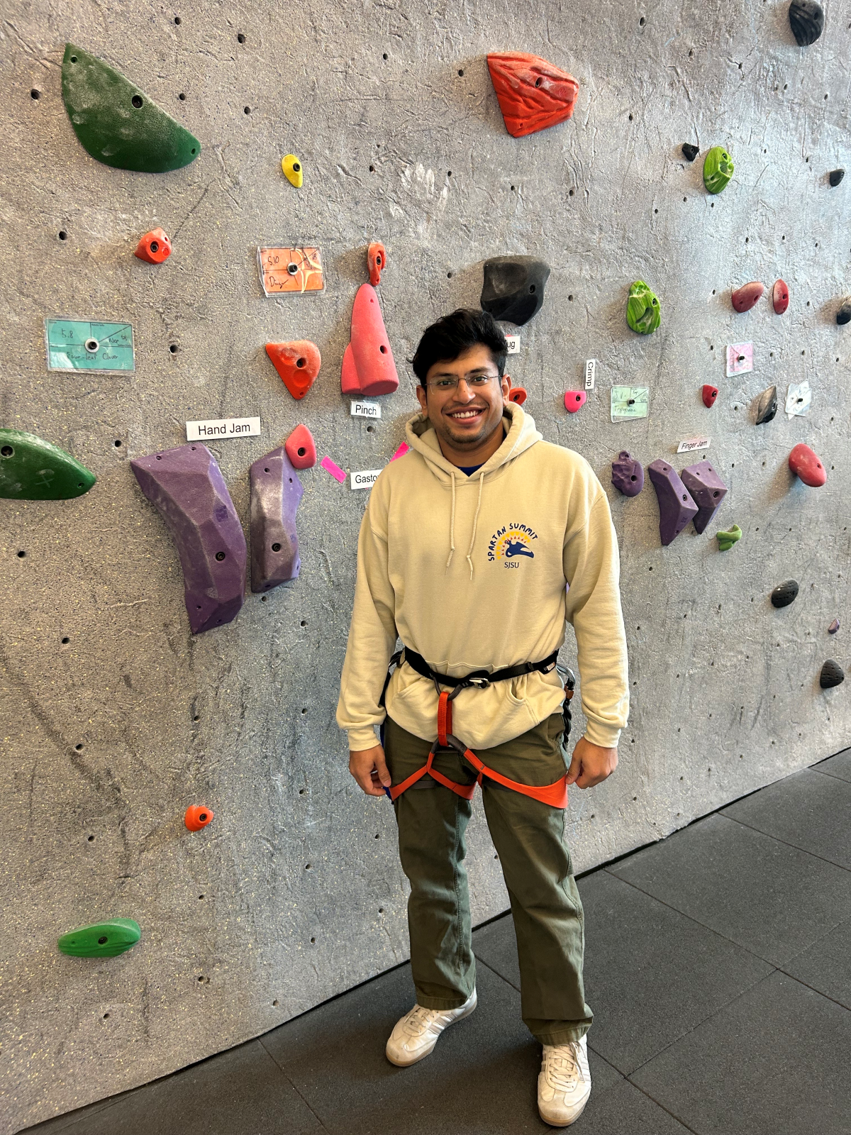 student at a climbing wall
