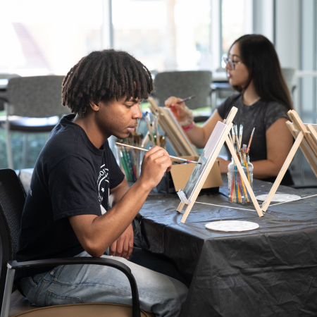 students painting at the wellness lounge